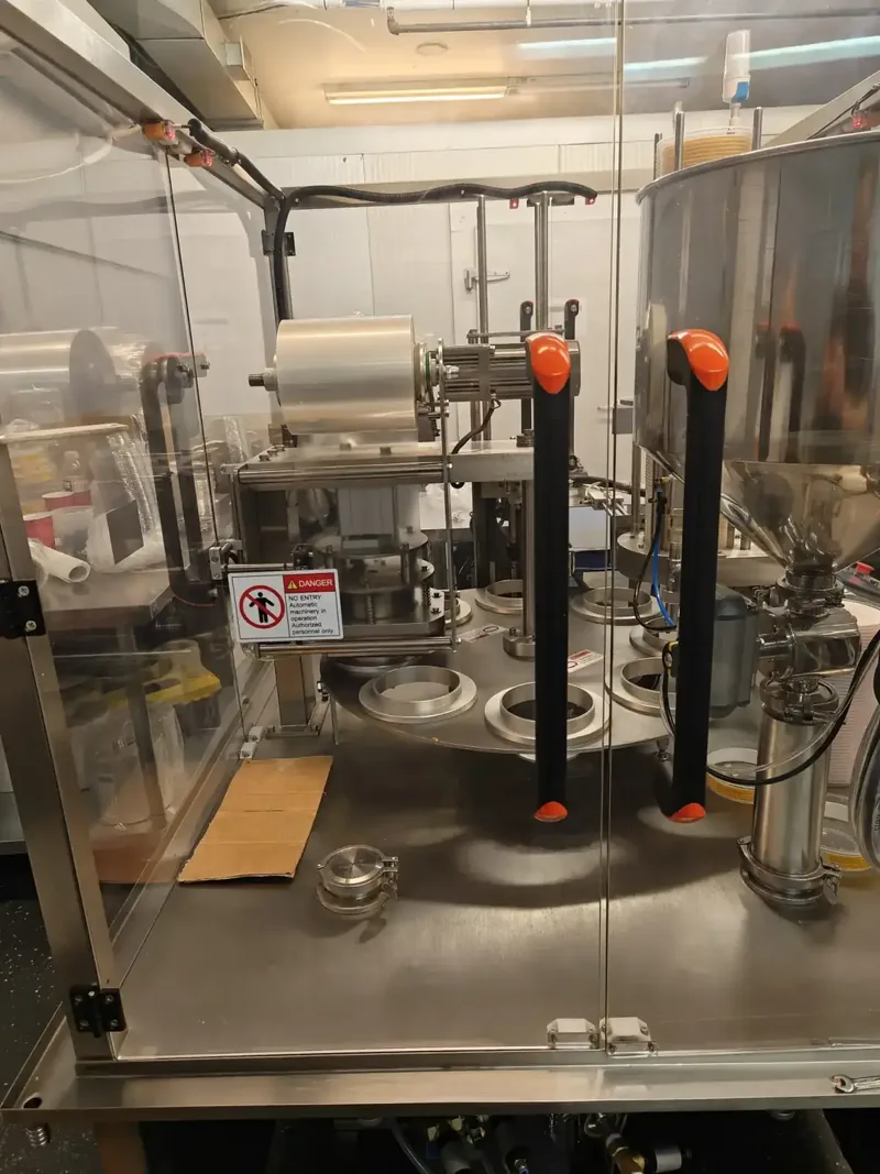 Interior view of SDH-R rotary table showing cup holders and film sealing mechanism